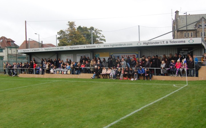 With the stands competely full, crowds gather around the pitch